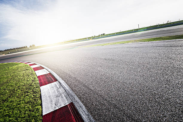 Asphalt Road View of an empty asphalt racing track. motor racing track photos stock pictures, royalty-free photos & images