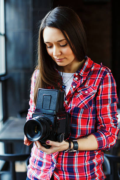 istock Young beautiful woman take a picture with retro camera 564593322