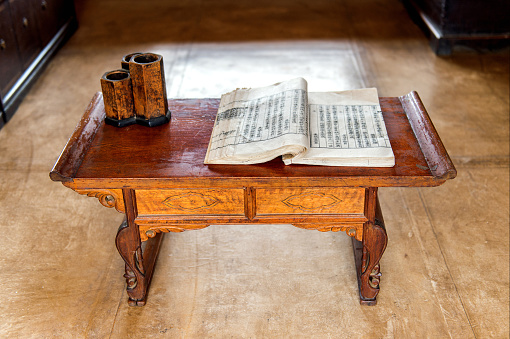 Old chinese book on wooden table.