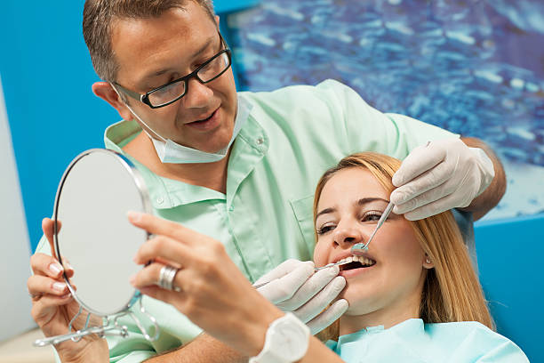 istock Satisfied dental patient looking at her teeth. 564594764