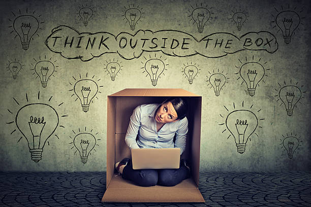 think outside box. woman sitting inside box - box thinking creativity inspiration imagens e fotografias de stock