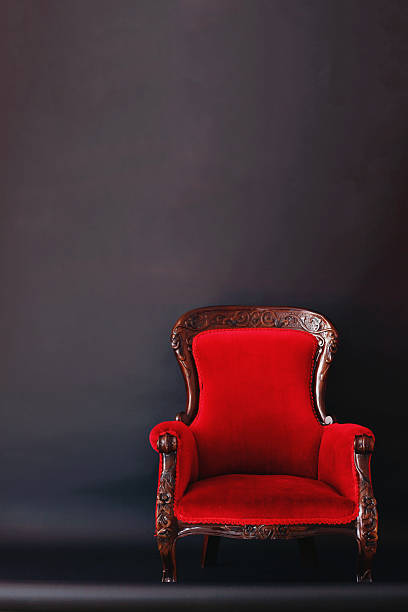istock Old styled red vintage armchair on black background 564596832