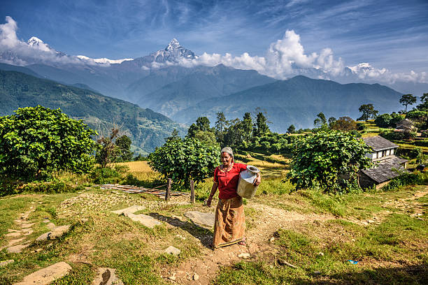 Nepalese woman in the Himalayas mountains Dhampus, Nepal - October 27, 2015 : Nepalese woman in front of her home in the Himalayas mountains near Pokhara nepalese culture stock pictures, royalty-free photos & images