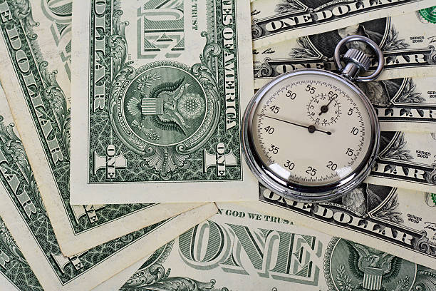시간 돈입니다  - finance photography us currency stopwatch 뉴스 사진 이미지