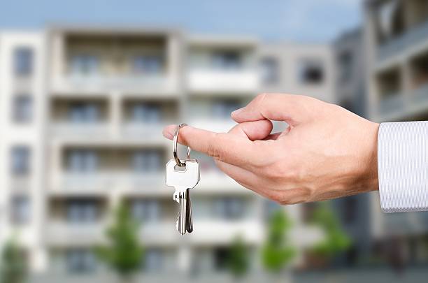 istock Man hand holding keys to new house 564600944