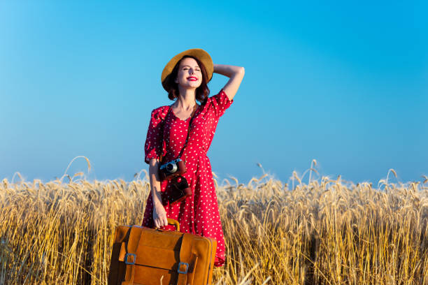 istock young woman with suitcase and camera 564604912