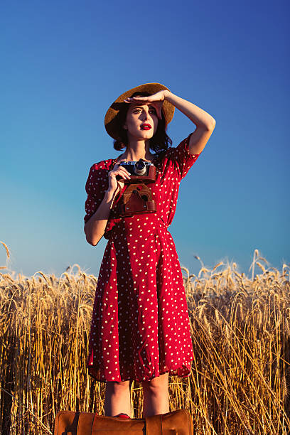 istock young woman with suitcase and camera 564605006