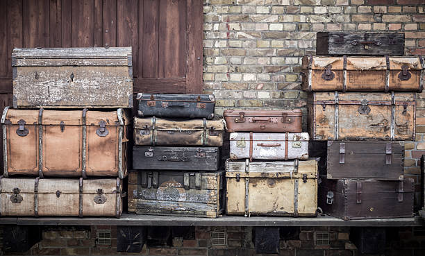 Vintage leather suitcases stacked vertically - Spreewald, Germany. June 2016 - Vintage leather suitcases stacked vertically - Spreewald, Germany suitcase luggage old fashioned obsolete stock pictures, royalty-free photos & images