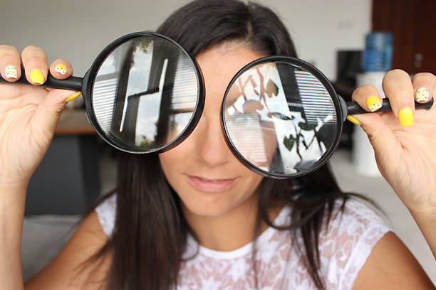 istock Woman looking through loupes 564606760