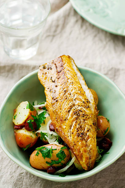 istock fried mackerel with potatoes in a bowl 564606802