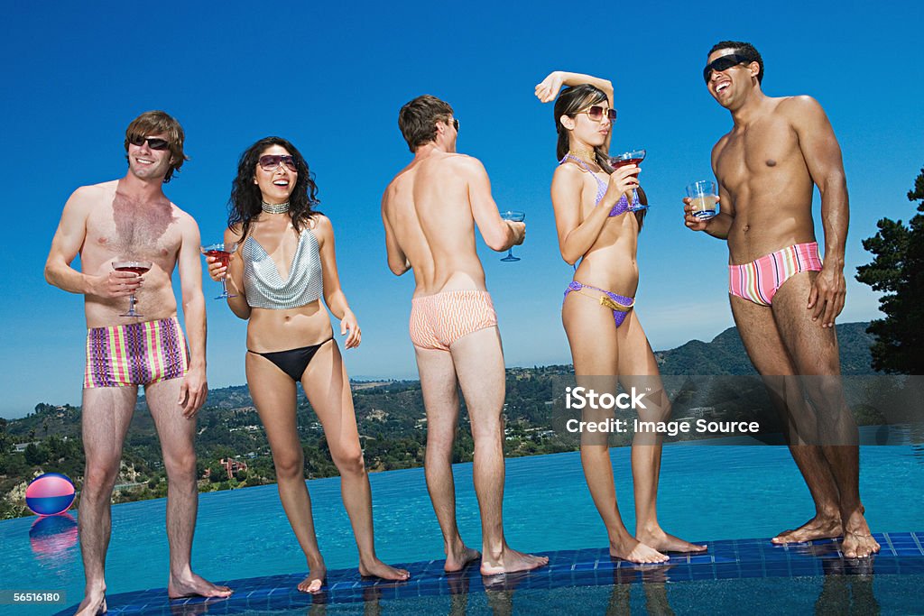 Friends drinking cocktails poolside  Cocktail Stock Photo