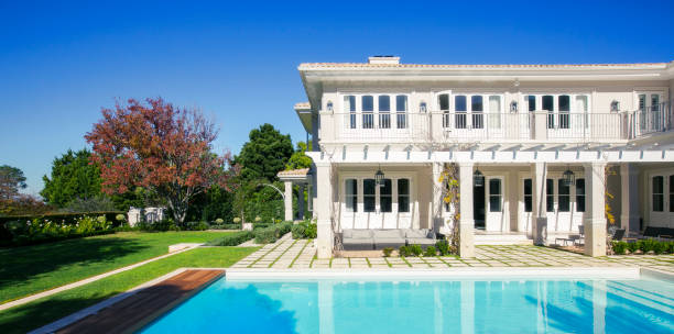 istock Swimming pool outside luxury house 568518369