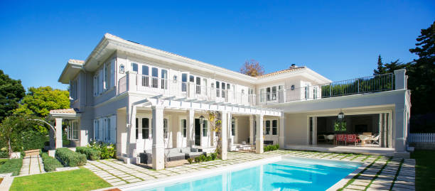 istock Swimming pool outside luxury house 568518397