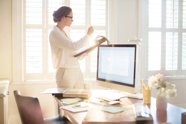 istock Interior designer looking at swatches in sunny home office 568518455
