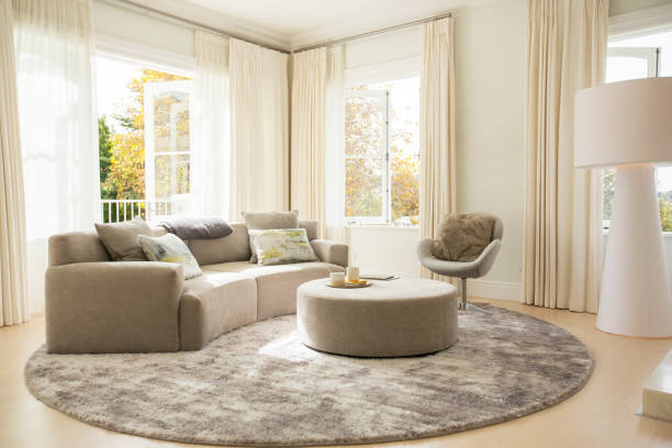 istock Round carpet under sofa and ottoman in living room 568518503