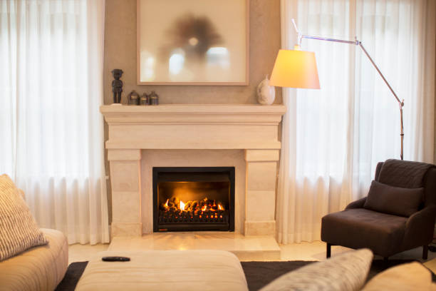 istock Illuminated floor lamp near marble fireplace 568518565