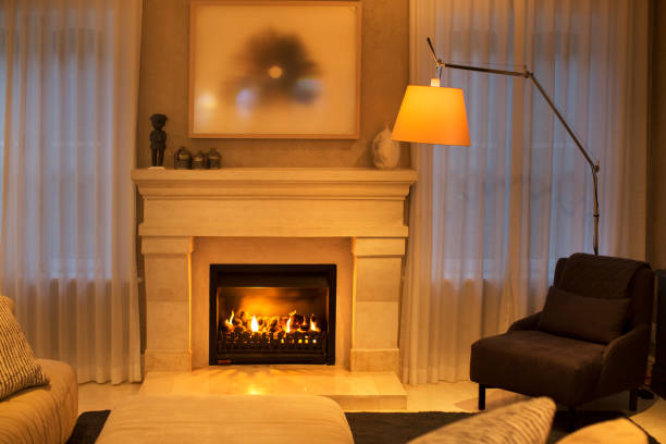 istock Illuminated floor lamp next to marble fireplace 568518593