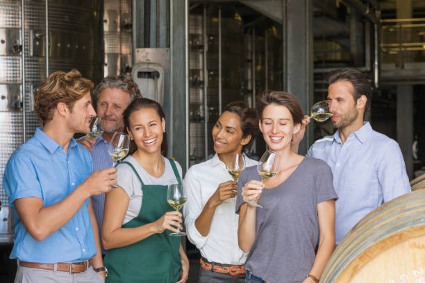 istock Winery employees tasting white wine in cellar 568518759