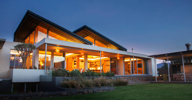 istock Illuminated luxury modern house at night 568518787