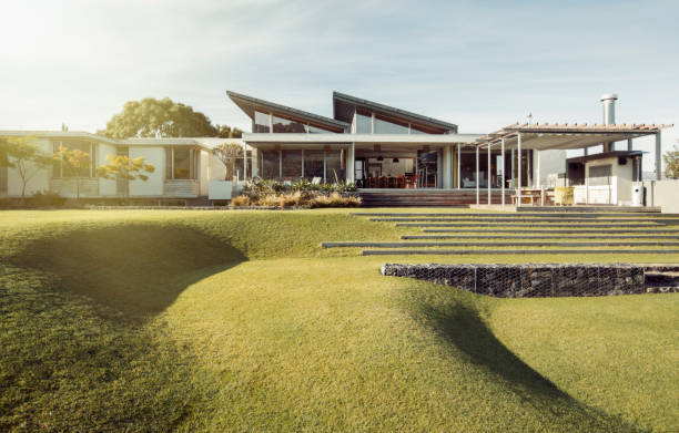 istock Sloped green yard and luxury house 568518807