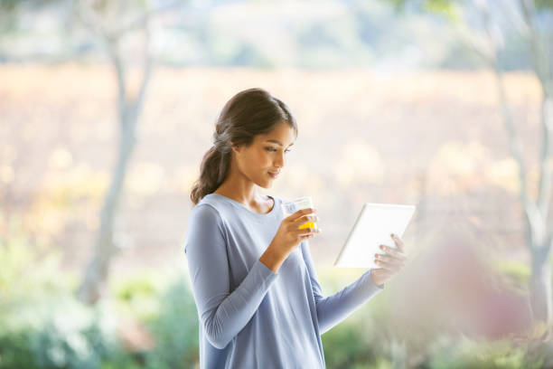 Young female  paying for a purchase using her smart phone and tablet