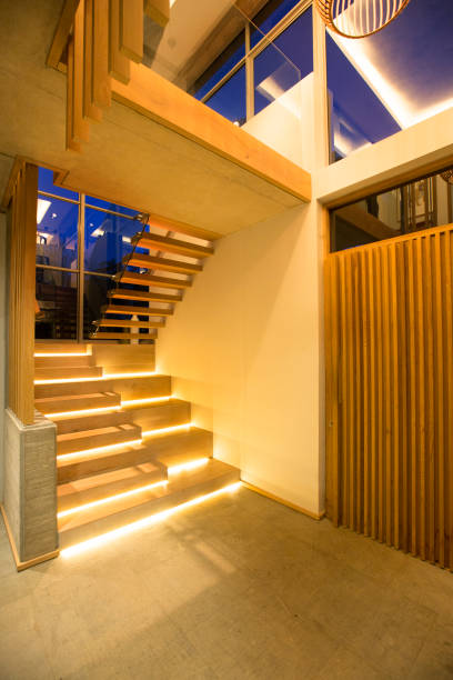 istock Illuminated modern stairs off foyer in luxury house 568519113