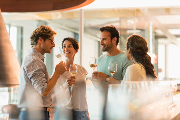 friends wine tasting white wine in winery tasting room - white wine wine white glass imagens e fotografias de stock