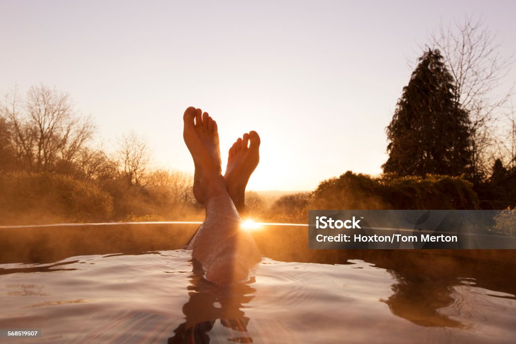 Mans feet raised out of pool  Hot Tub Stock Photo