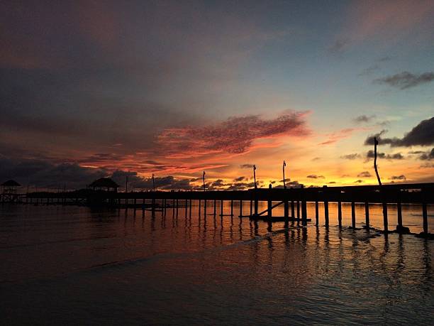 istock Moody sky over jetty at low tide 569179007