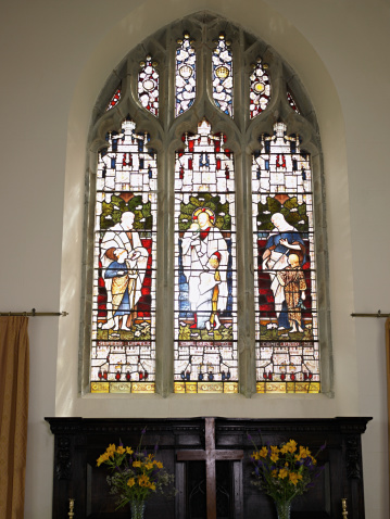 A Victorian stained glass window in the parish church of St Lawrence, in the pretty village of Castle Rising in Norfolk, Eastern England.
