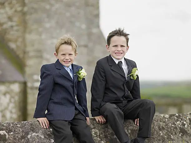 Photo of Two boys on wall outside church