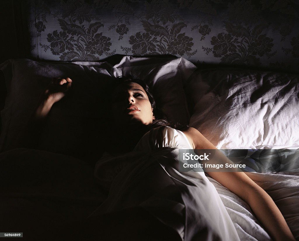Woman lying in bed  Insomnia Stock Photo