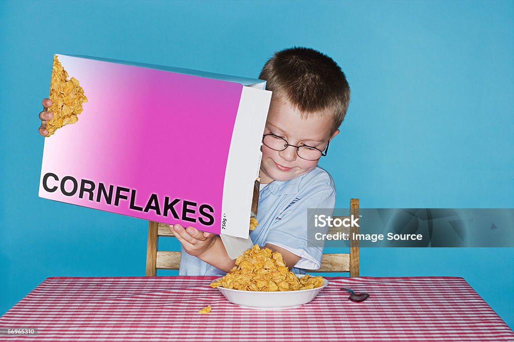 Boy pouring cornflakes  Corn Flakes Stock Photo