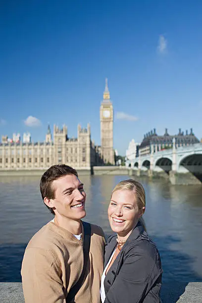 Photo of Couple by river near Houses of Parliament