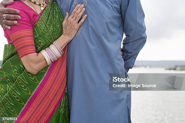 Indian Couple By The Sea Stock Photo - Download Image Now - 50-59 Years, 60-69 Years, Active Seniors