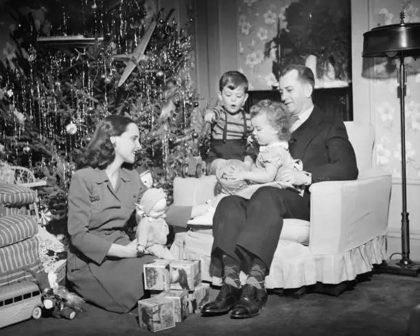 Photo of Family opening Christmas presents, children (2-3) (4-5), (B&W)