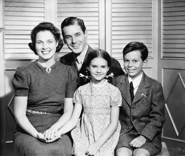 Photo of Family posing at home, children (8-9) (10-11), (B&W), portrait