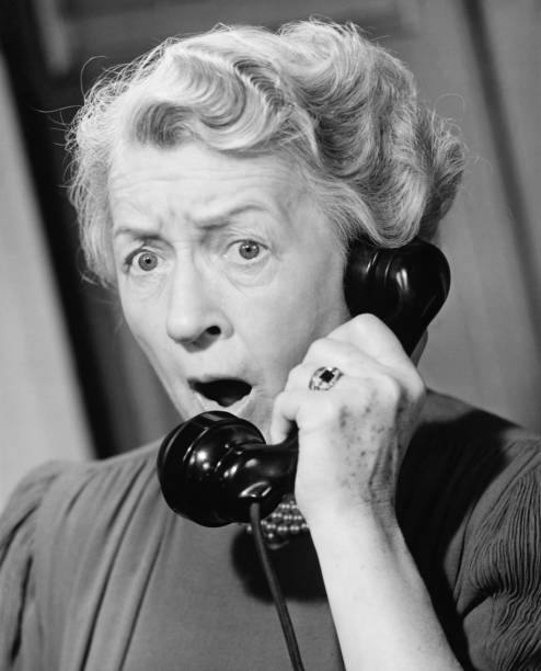 Shocked woman using phone, (B&W), close-up  frowning headshot close up studio shot stock pictures, royalty-free photos & images