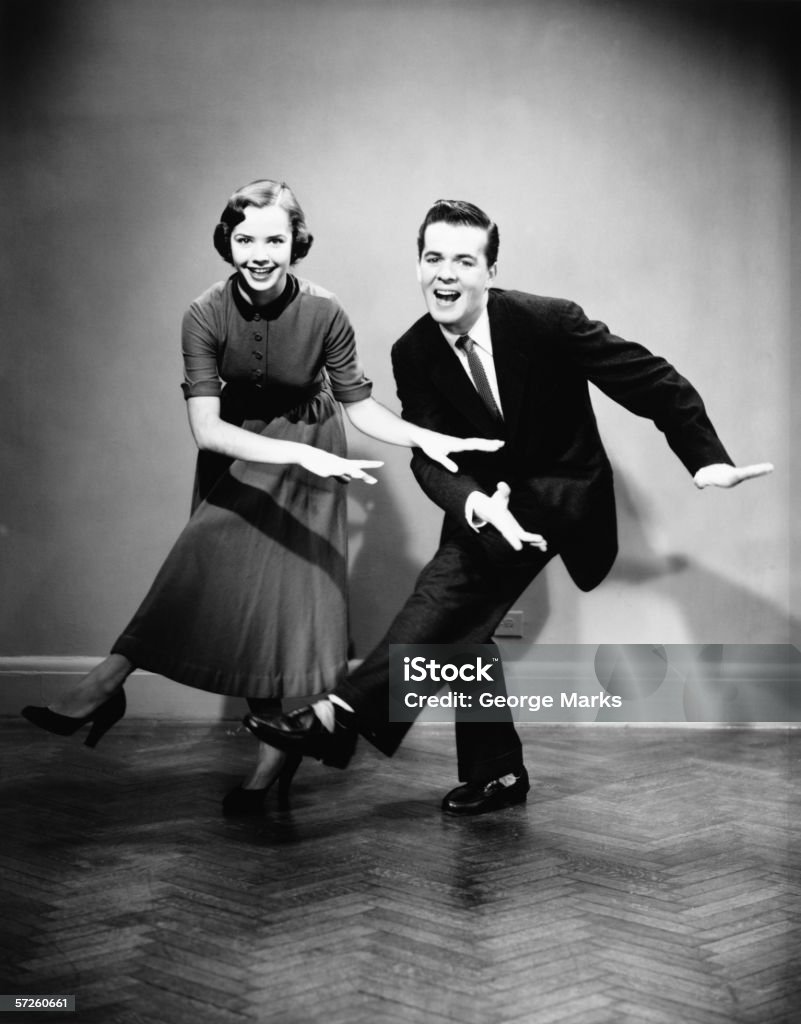 Young couple dancing in empty room, (B&W)  Old-fashioned Stock Photo