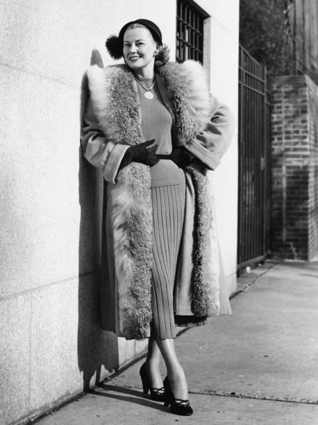 Woman wearing fur coat posing outdoors, (B&W), (Portrait)  high society photos stock pictures, royalty-free photos & images