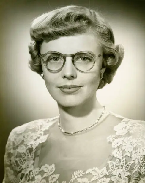 Photo of Woman wearing lace dress posing in studio, (B&W), (Close-up), (Portrait)