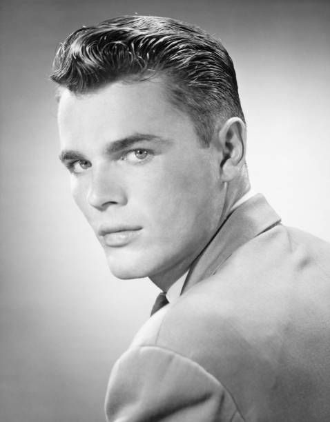 Young man posing in studio, (B&W), (Close-up), (Portrait)  vintage hairstyle stock pictures, royalty-free photos & images