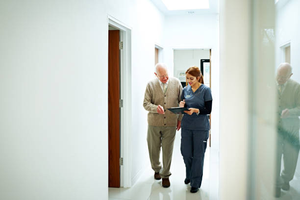 Nurse sharing medical report with senior patient
