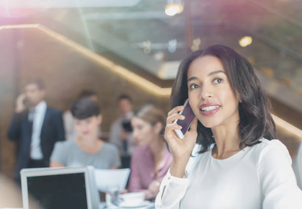 istock Businesswoman talking on cell phone in office 575131419