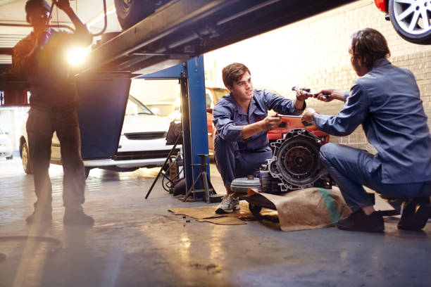 istock Mechanics discussing part in auto repair shop 575131929