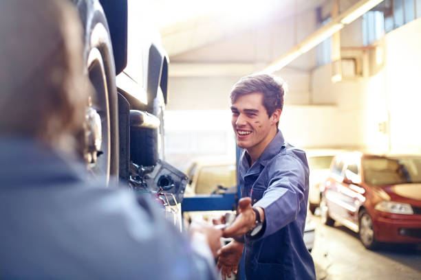 istock Mechanic reaching for tool in auto repair shop 575132005