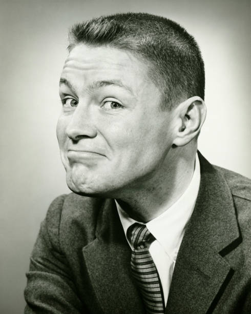 Man making face in studio, (B&W), close-up  crew cut stock pictures, royalty-free photos & images