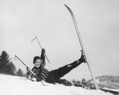 Young woman skier fallen in snow, (B&W)