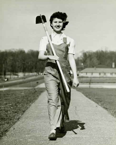 Woman with hoe walking on path, (B&W), portrait  garden hoe photos stock pictures, royalty-free photos & images