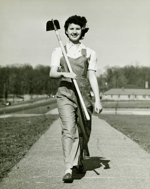 Woman with hoe walking on path, (B&W), portrait garden hoe photos stock pictures, royalty-free photos & images